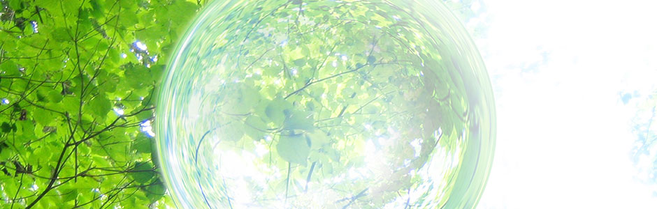 Bright green leaves and branches with a glowing glass orb overlay, light and airy mood with green and white tones